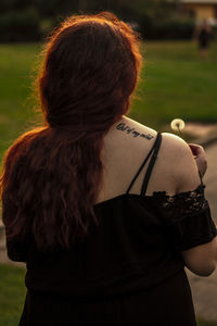 Rear view of woman standing in park