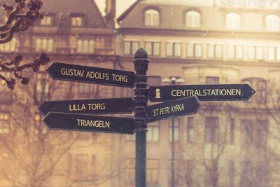 Signpost against building
