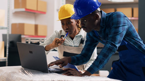 Rear view of man working at office