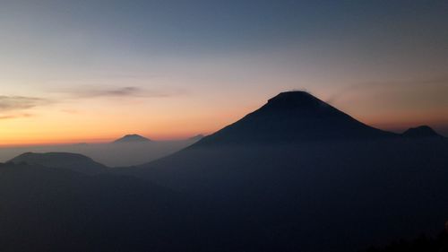 Scenic view of silhouette mountains against sky during sunset