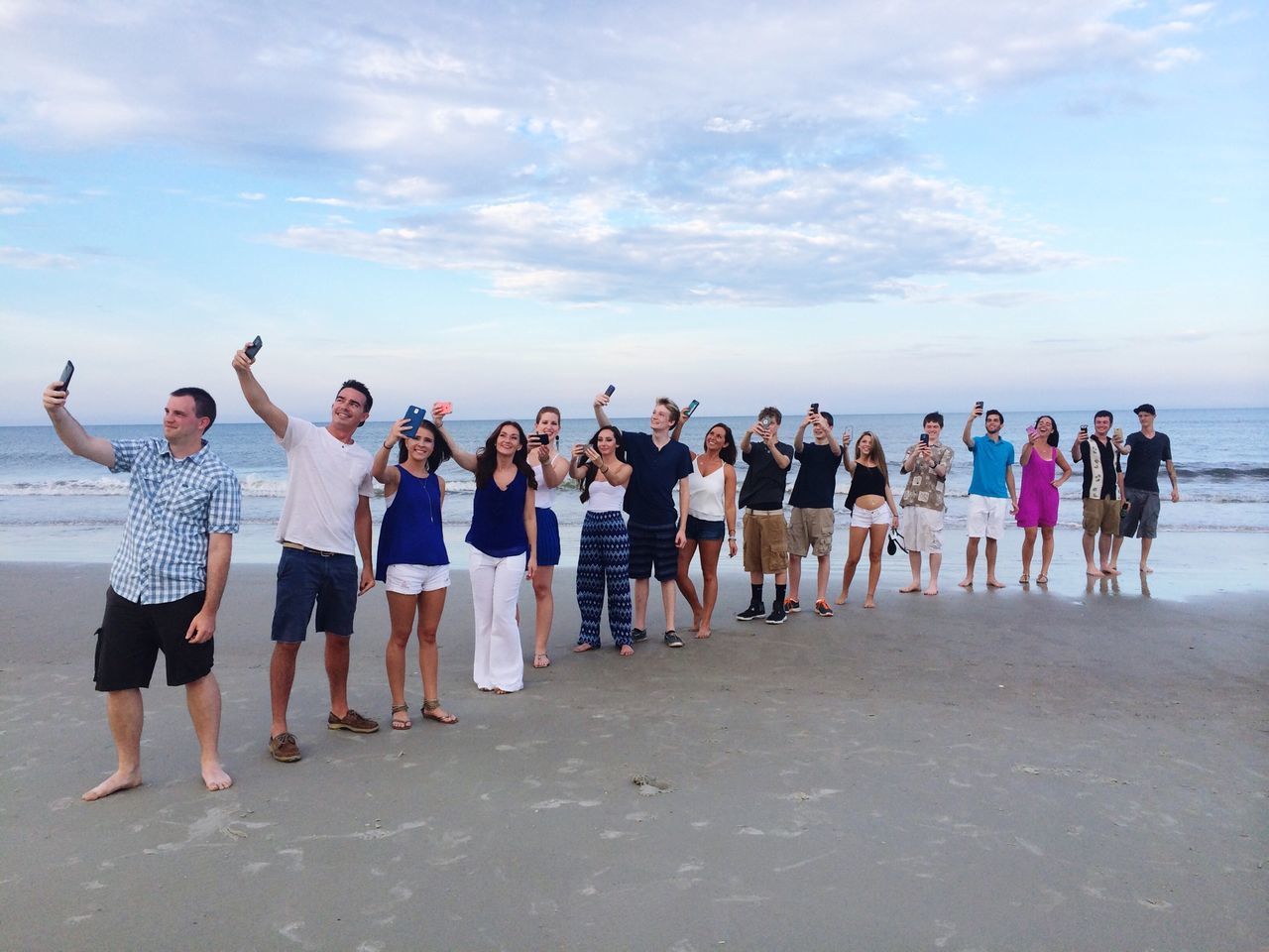 sky, bird, beach, animal themes, cloud - sky, men, full length, leisure activity, sand, lifestyles, sea, person, standing, flock of birds, shore, togetherness, cloud, in a row