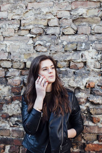 Portrait of young woman talking on mobile phone