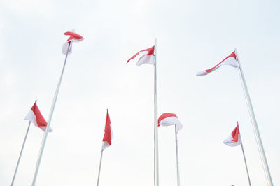 Low angle view of flags against sky