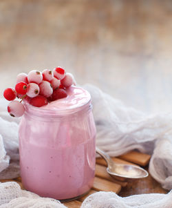 Close-up of strawberries in glass jar on table