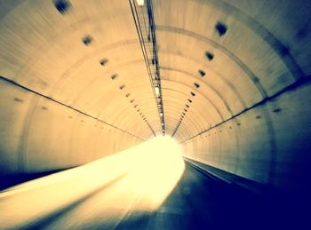 Low angle view of illuminated tunnel