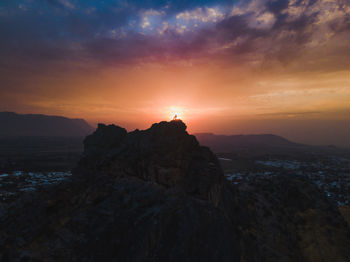 Mountain against cloudy sky during sunset