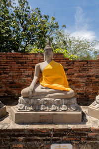 Statue of buddha against trees