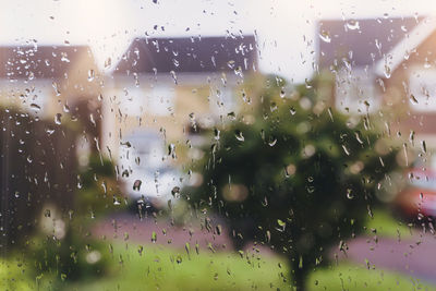 Full frame shot of wet glass window in rainy season