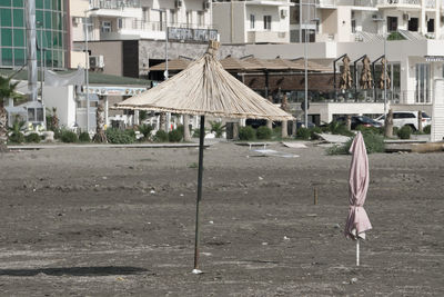 View of deserted beach against city buildings