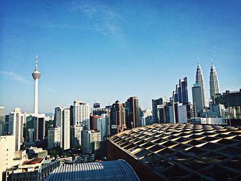 High angle view of cityscape and kuala lumpur tower against sky