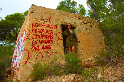 Full length of woman standing against plants
