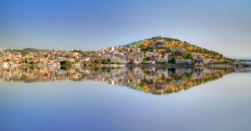 Panoramic shot of townscape by lake against sky