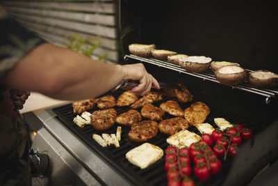 Man grilling meat on barbecue