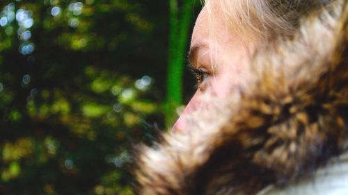 Close-up of thoughtful woman wearing fur coat