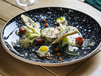 High angle view of food in black plate on table