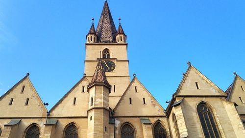 Low angle view of building against blue sky