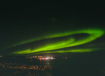 Scenic view of lake against sky at night