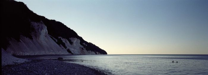 Scenic view of sea against clear sky during sunset