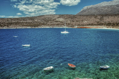 Scenic view of sea and mountains against sky