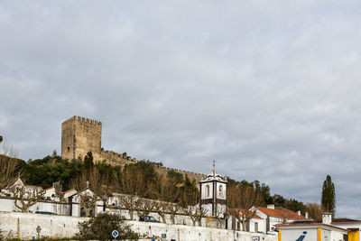 Buildings and castle against sky in city