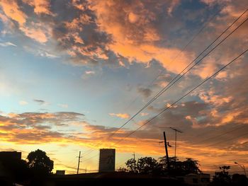 View of city against cloudy sky during sunset