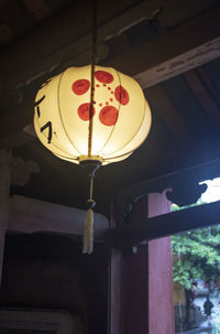 Low angle view of illuminated lantern hanging on ceiling in building