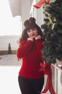 Side view of young woman standing at home