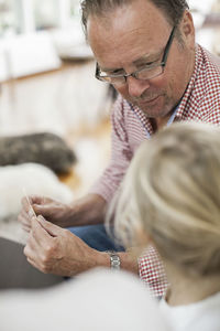 Grandfather and granddaughter playing card puzzle game at home