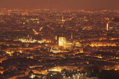 High angle view of illuminated city buildings at night