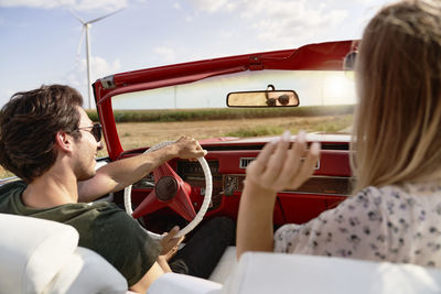 Rear view of woman sitting in car