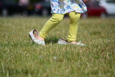 Low section of shoes on grass