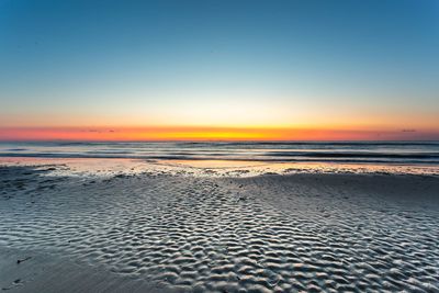 Scenic view of sea against clear sky during sunset