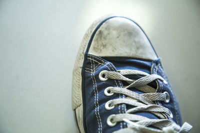 Cropped image of man wearing purple canvas shoe