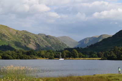 Scenic view of lake and mountains against sky