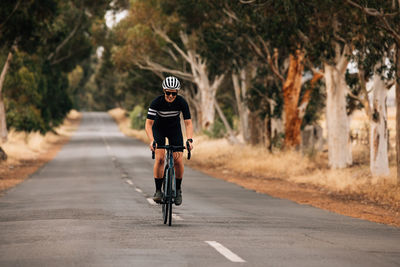 Man riding bicycle on road