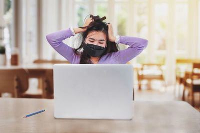 Mid section of woman using mobile phone