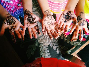 High angle view of people with henna tattoo