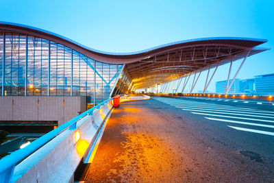 View of bridge in city against blue sky