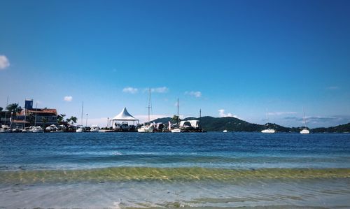 Scenic view of sea against clear blue sky