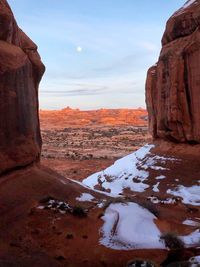 Scenic view of rock formations against sky during winter