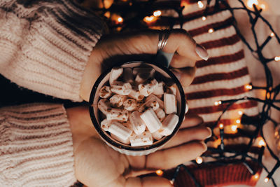 Woman holding bowl of marshmallows