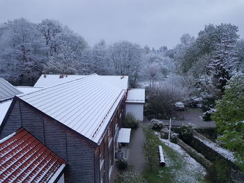 High angle view of houses against trees during winter