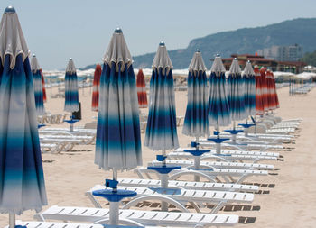 Panoramic view of lounge chairs on beach