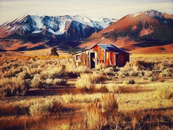 Built structure on field against mountain range