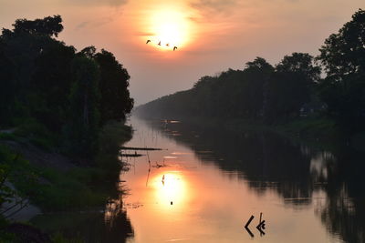 Scenic view of lake against sky during sunset