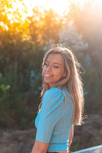 Portrait of a smiling young woman standing outdoors