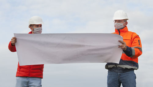 Midsection of man working with umbrella
