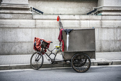 Bicycle parked against wall in city