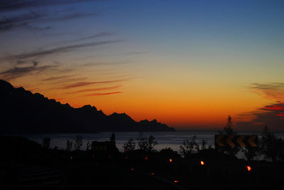 Scenic view of lake against orange sky