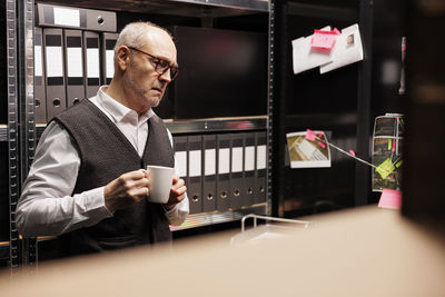 Side view of businessman using mobile phone